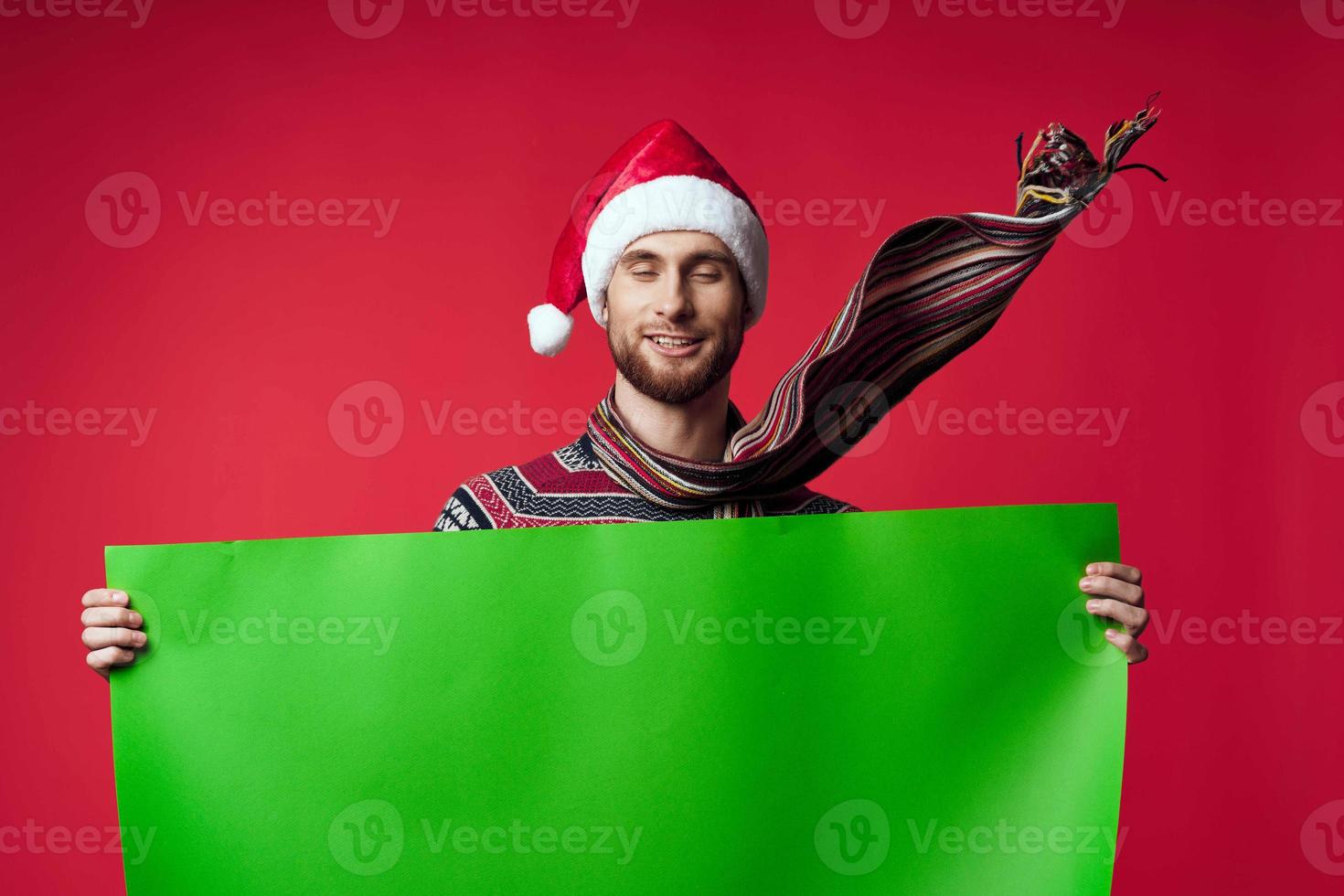 emotional man in a santa hat holding a banner holiday isolated background photo