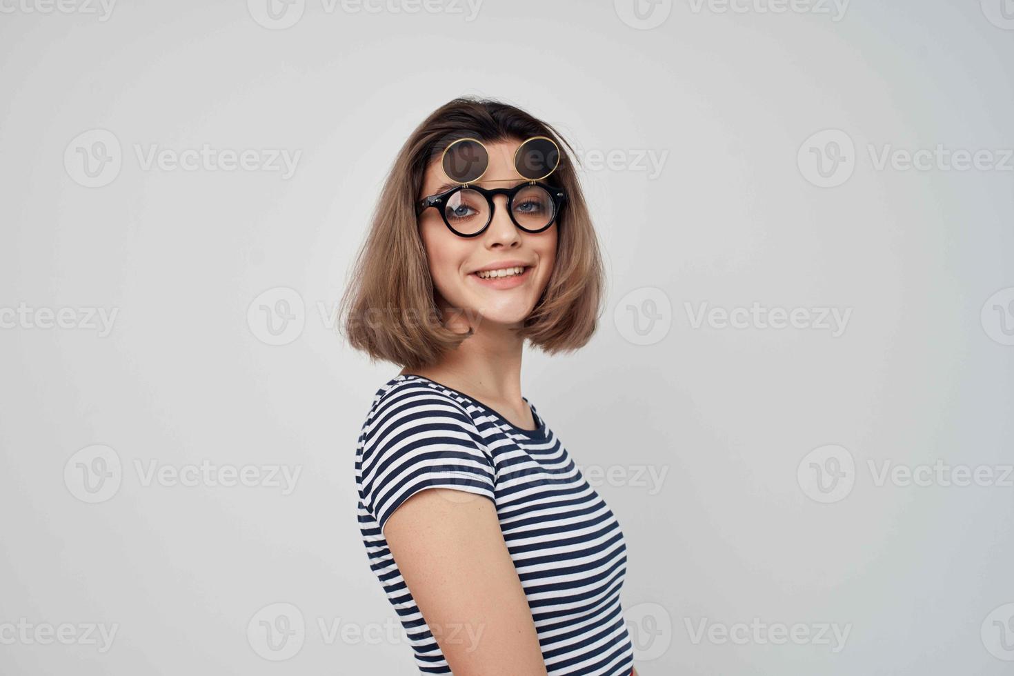 woman in striped t-shirt fashion glasses studio posing photo