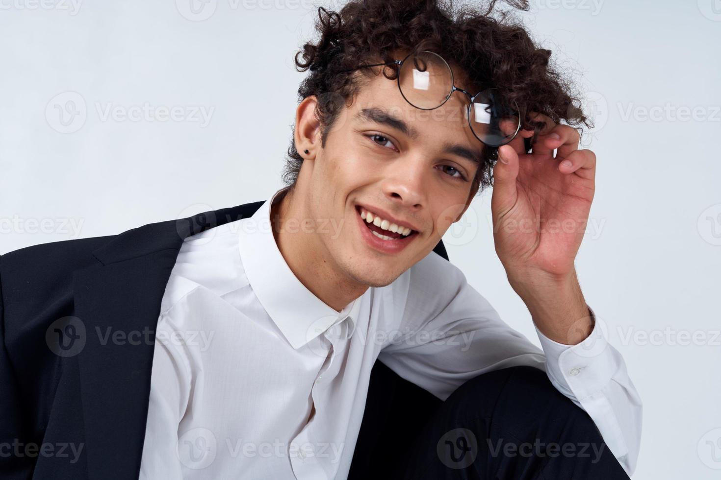 pretty guy in glasses and in a classic suit on a light background portrait close-up fashion style photo