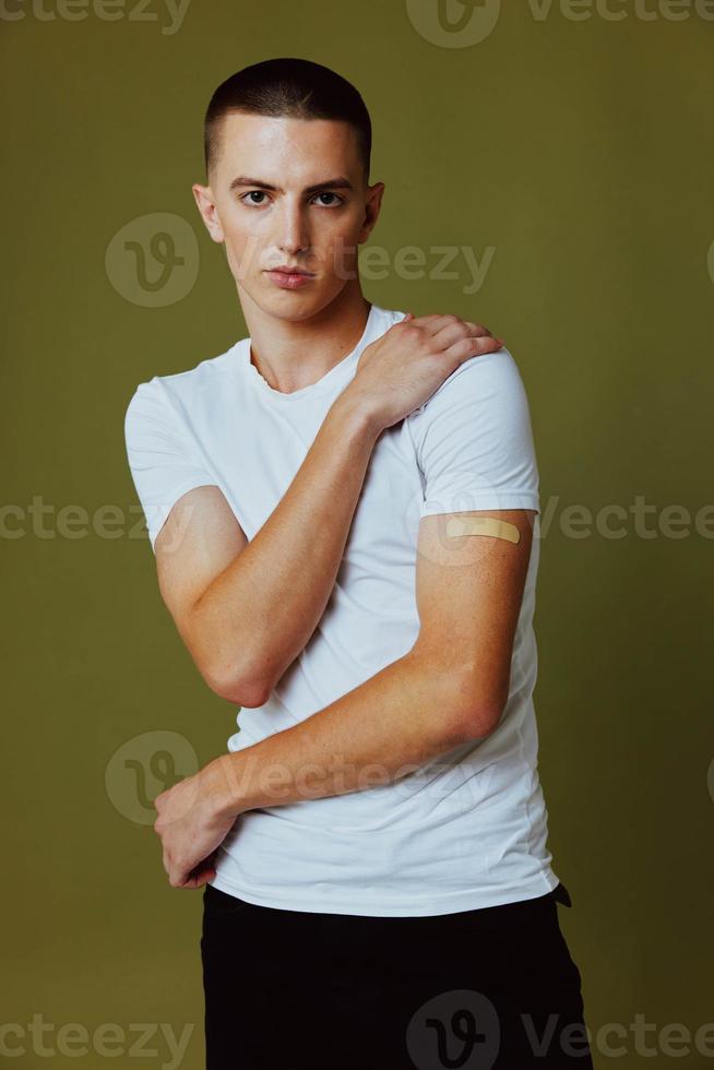 guy with adhesive plaster on hand covid-19 vaccination passport isolated background photo