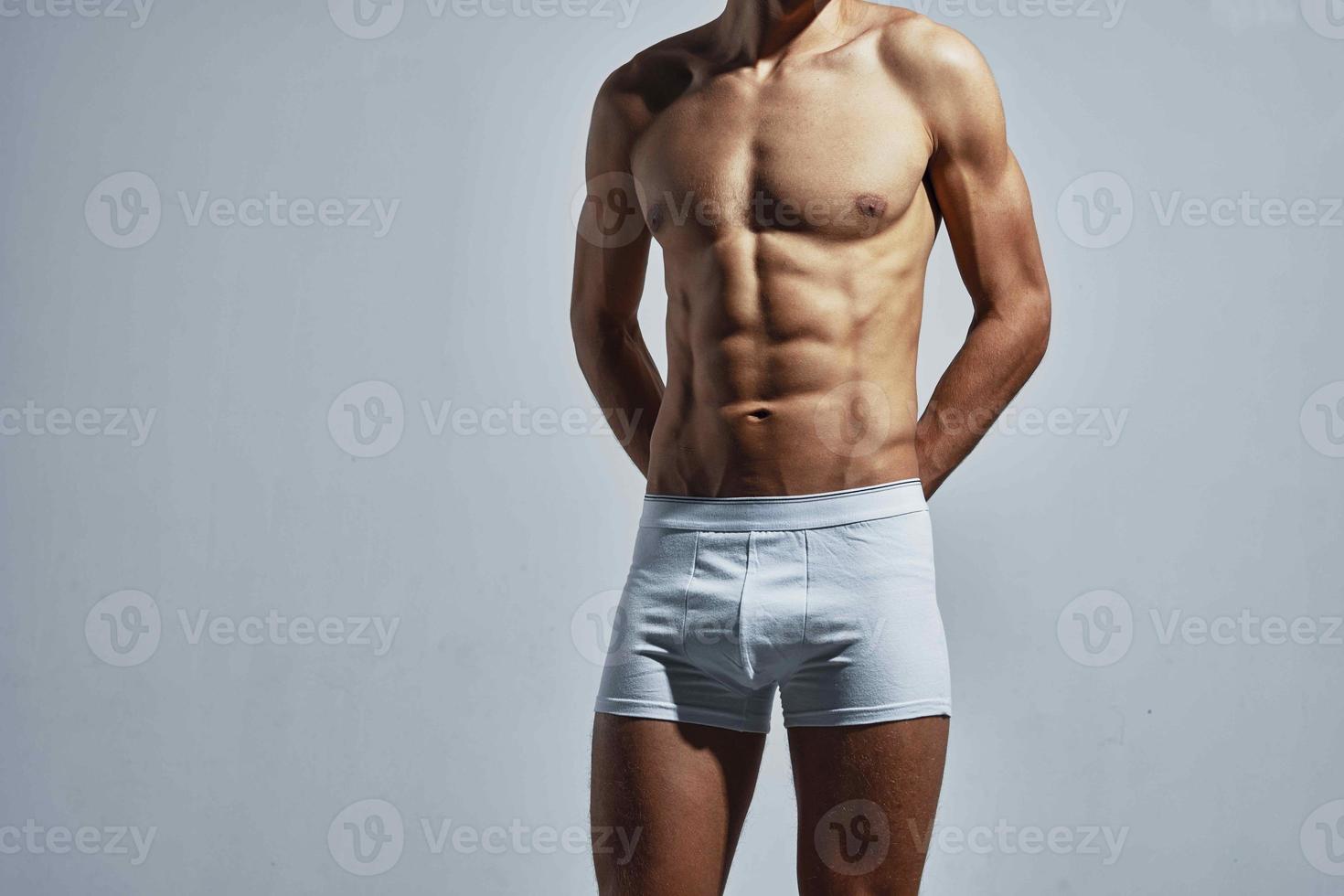 male athlete in white shorts pumped up press posing photo