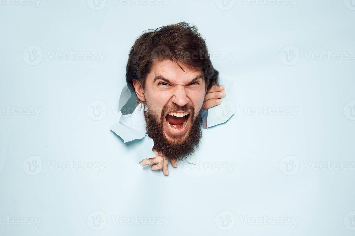 screaming bearded man peeking out from behind the wall emotions work photo