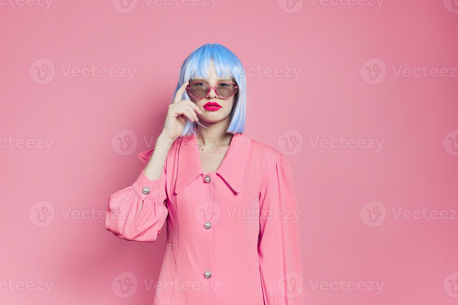portrait of a woman bright makeup fashion sunglasses pink background photo