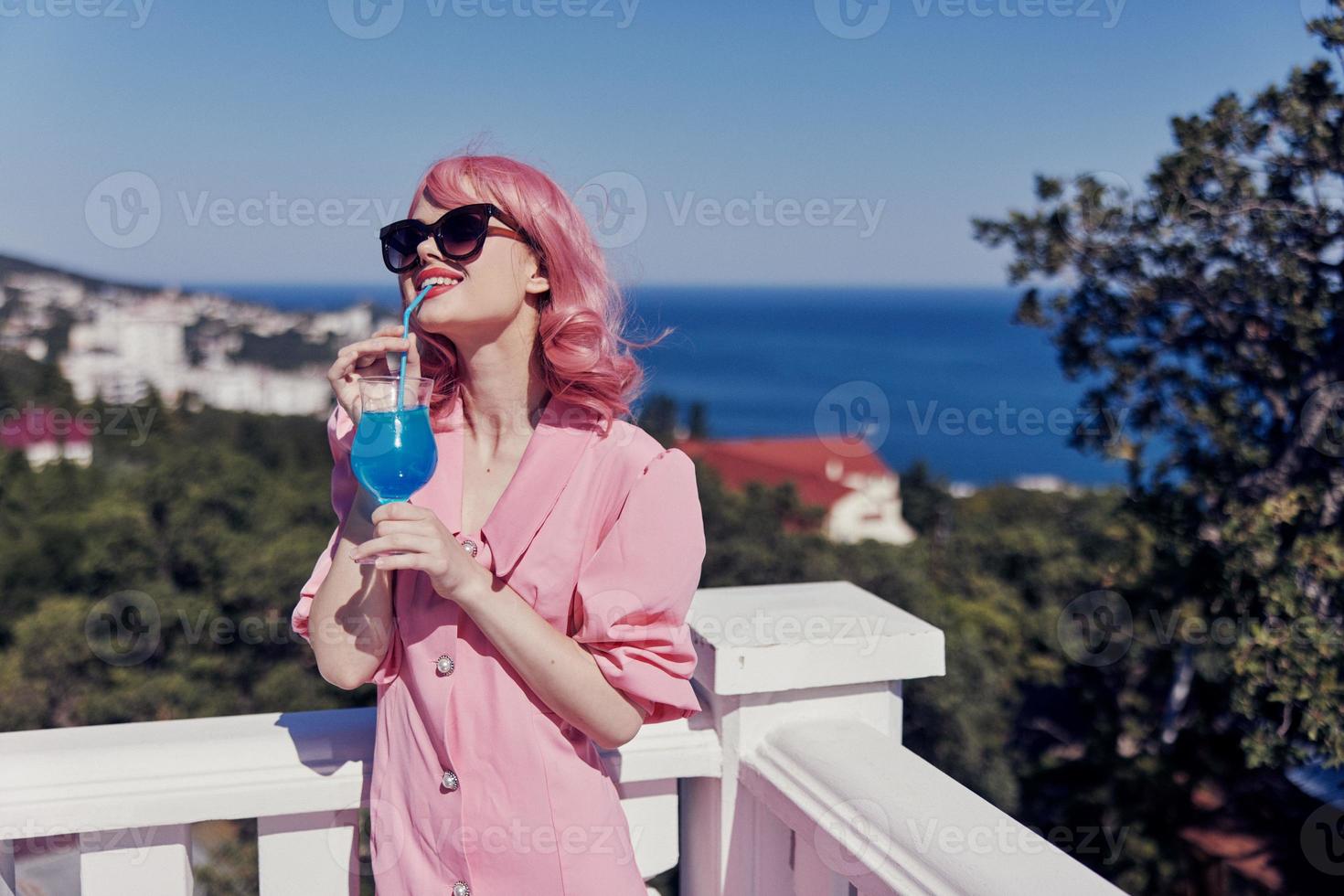 attractive woman in sunglasses outdoors on the terrace cocktail relaxing Drinking alcohol photo