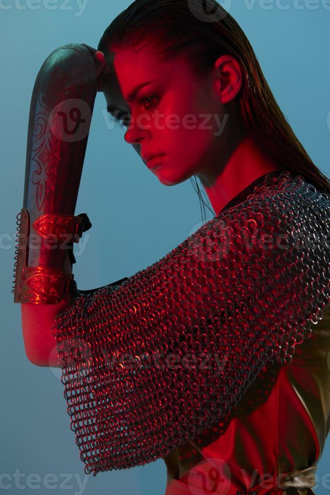 young woman Glamor posing red light metal armor on hand isolated background photo