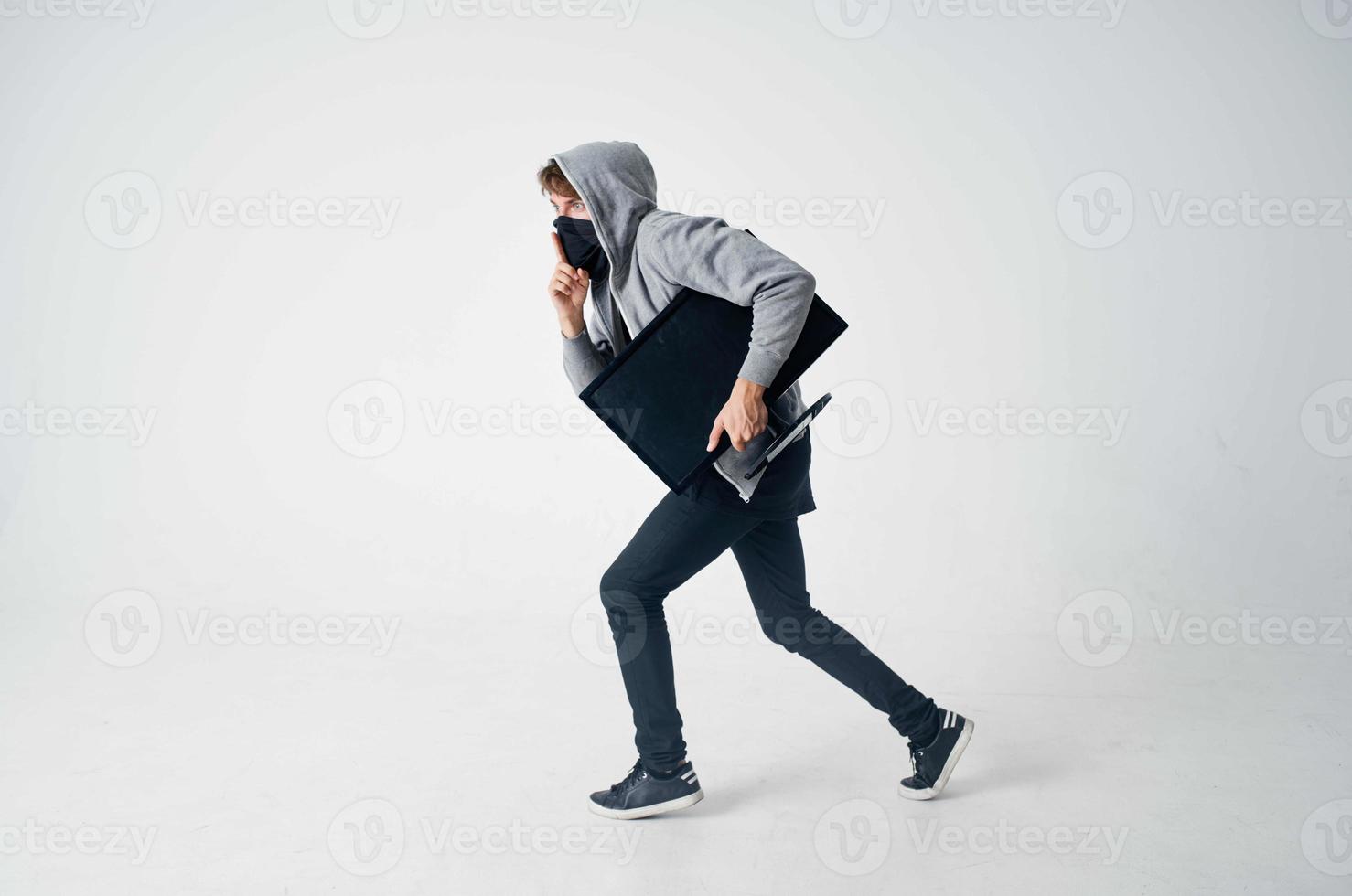 masked man stealth technique robbery safety hooligan light background photo