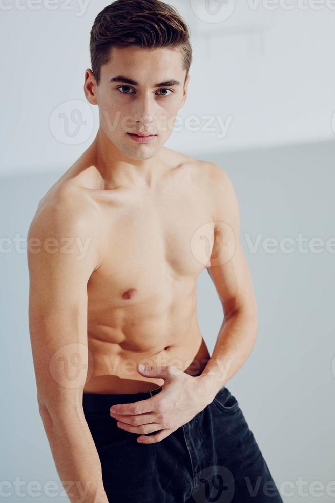 Semi-nude man in black pants with pumped muscles fitness sport photo