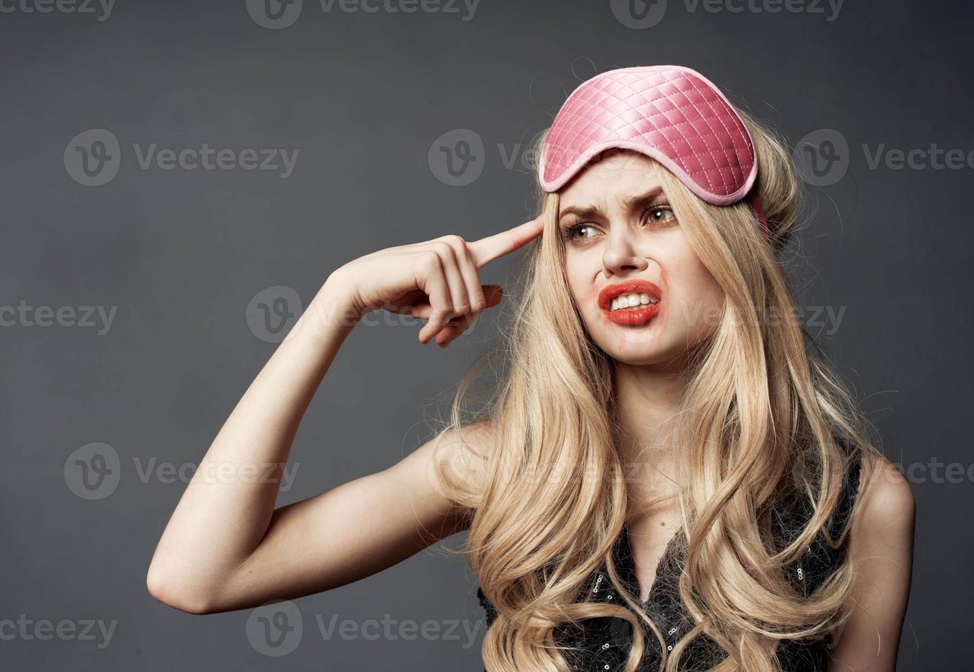 Blonde woman with pink mask for sleep alcoholism health problems model photo