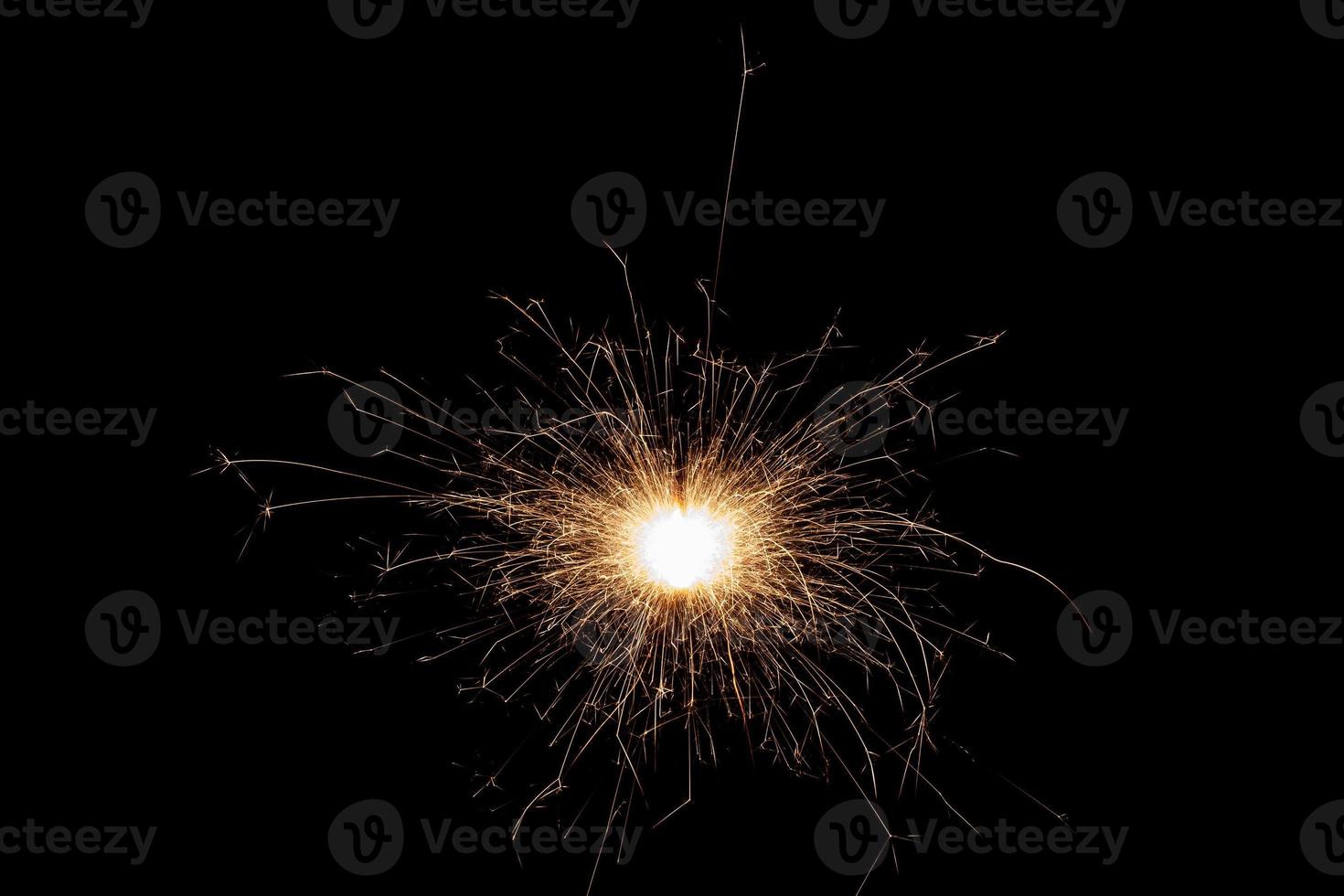 Burning sparkler isolated on black background. Fireworks theme. Light effect and texture. photo