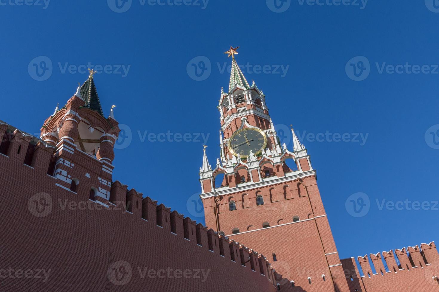 view on Spasskaya tower of Moscow Kremlin against blue sky photo