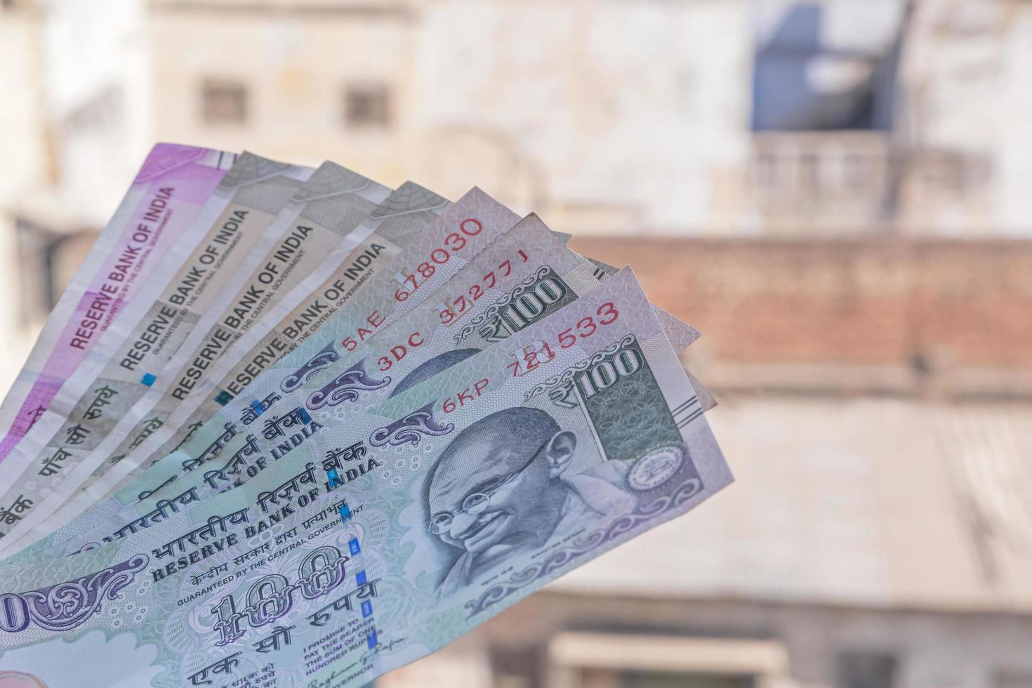 Indian rupee banknotes against old buildings photo
