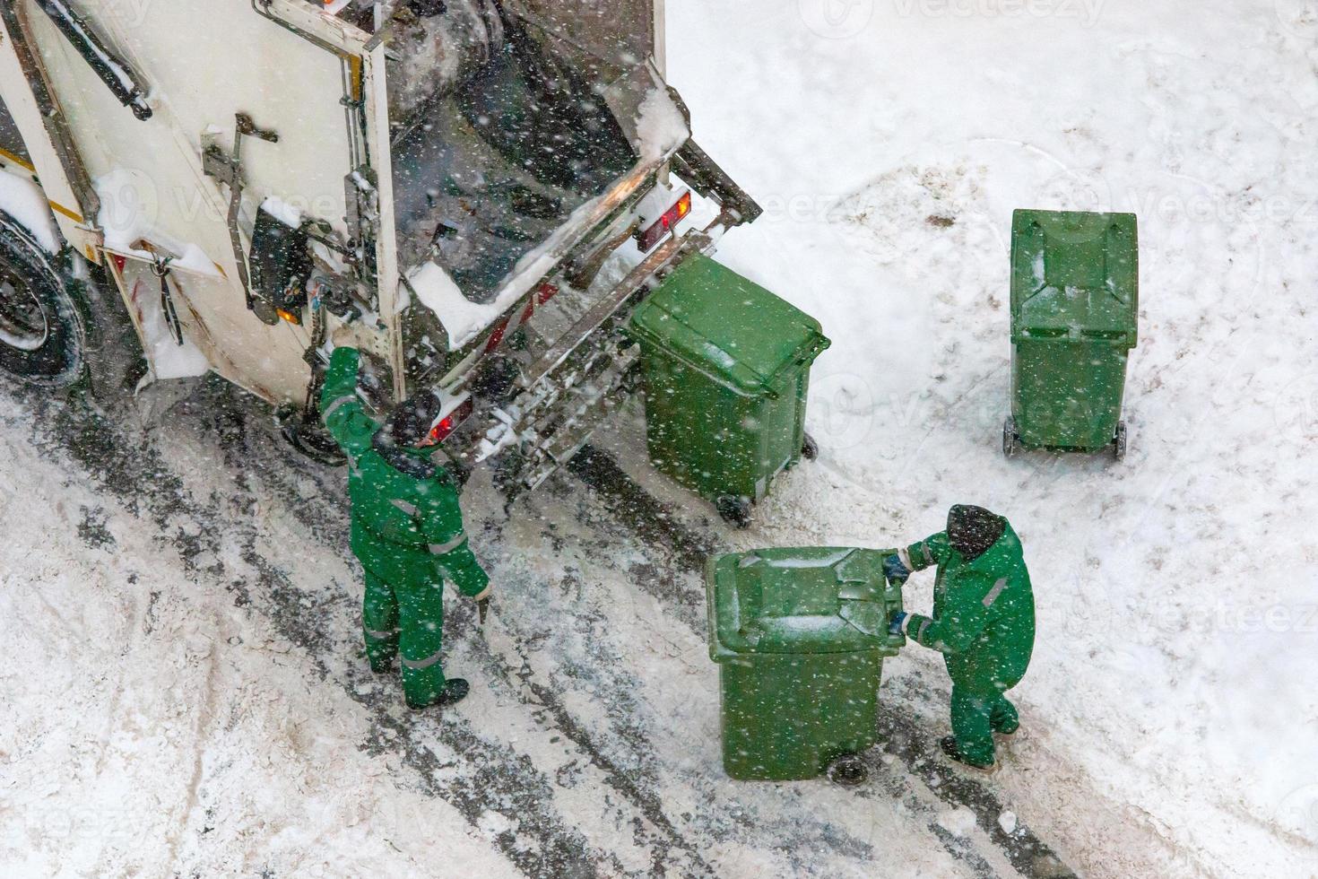 Garbage collection in winter snowy weather photo
