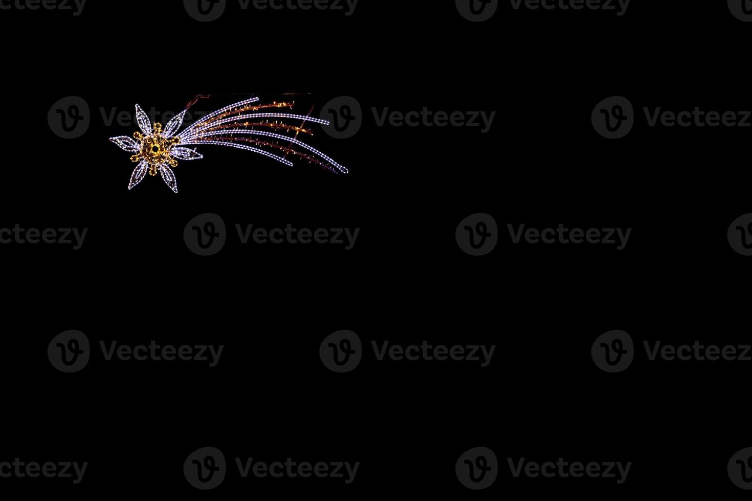 light illumination of the Star of Bethlehem on a black smooth background photo