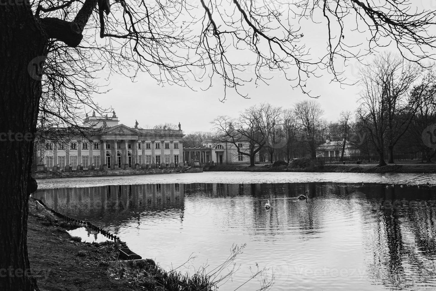 water palace in the roya park in poland on the pond on an autumn day photo