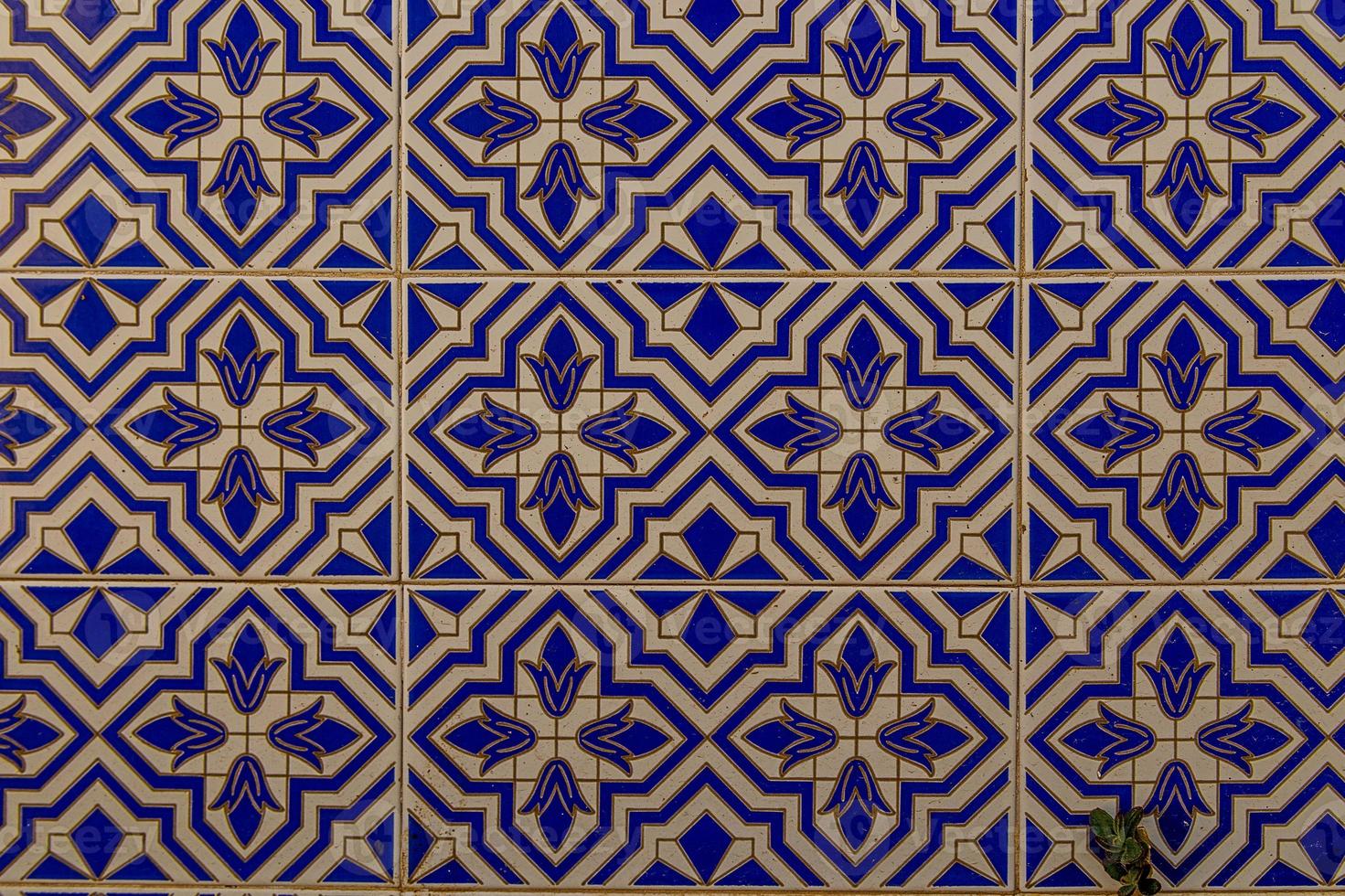 background of white-blue ceramic tiles with classic spanish patterns photo