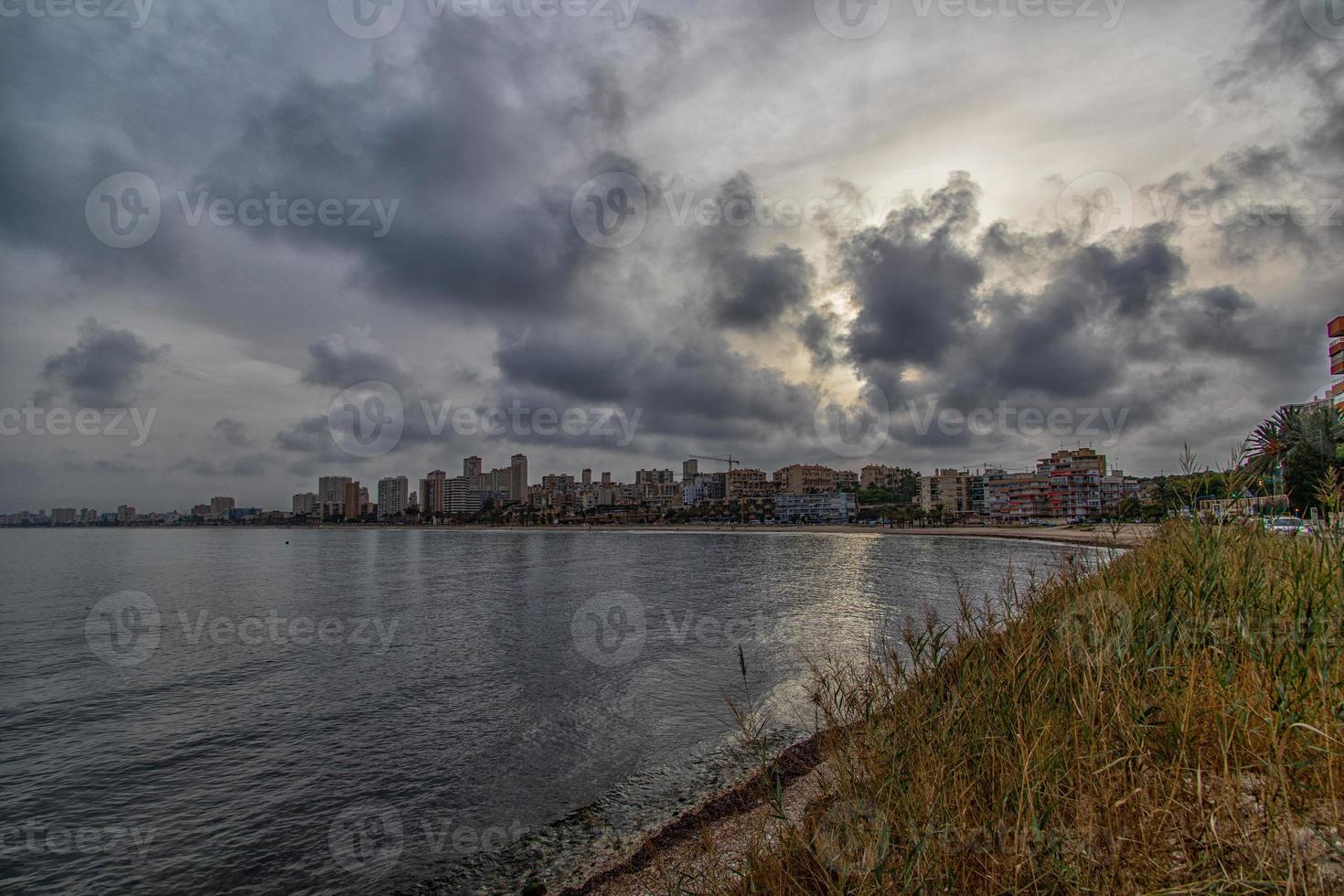 seaside landscape with sunset Alicante Spain with clouds in the sky photo