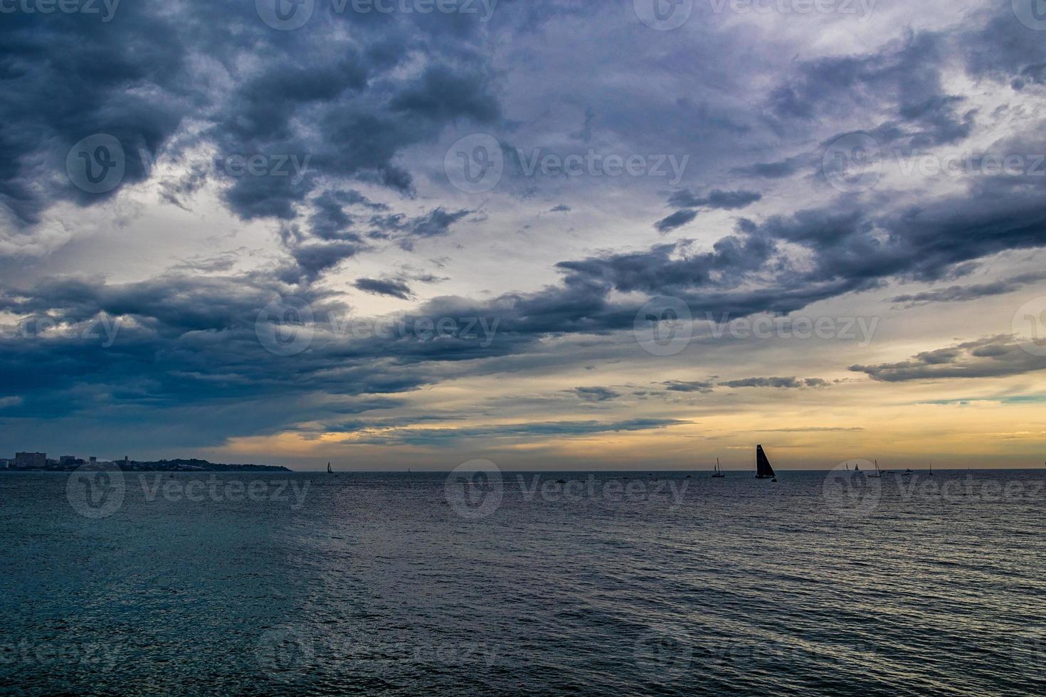 seaside landscape with clouds and sailboat on the horizon Alicante Spain photo
