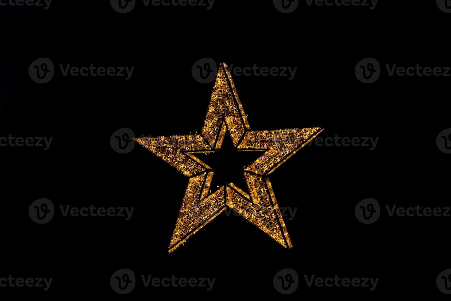 golden decoration shining star christmas decoration on black background photo