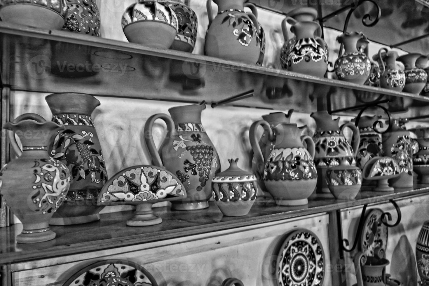 handmade clay dishes in the Greek style in the shop at the potter's workshop photo