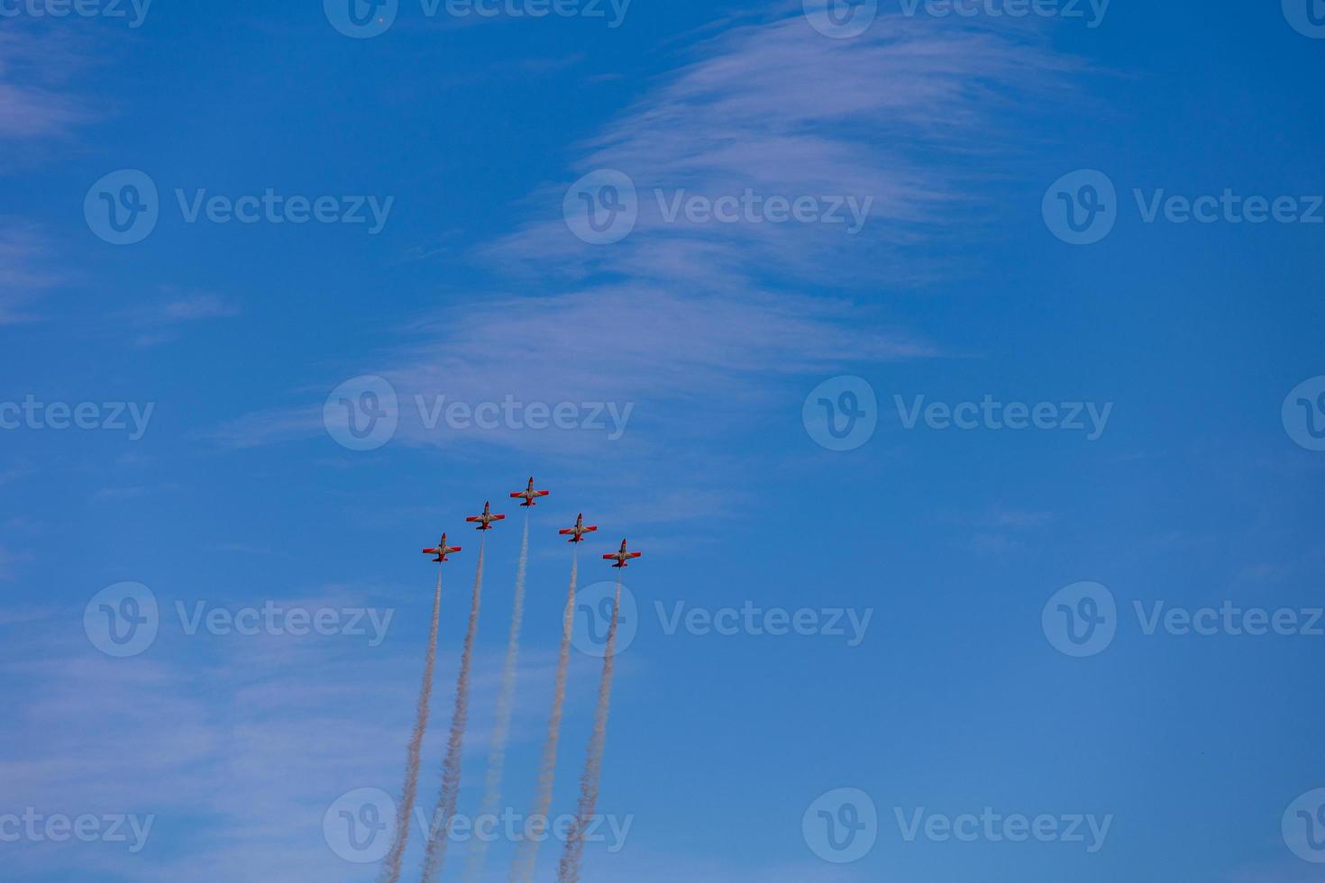 flight of five cessna planes over alicante smoke spanish flag against the blue sky photo