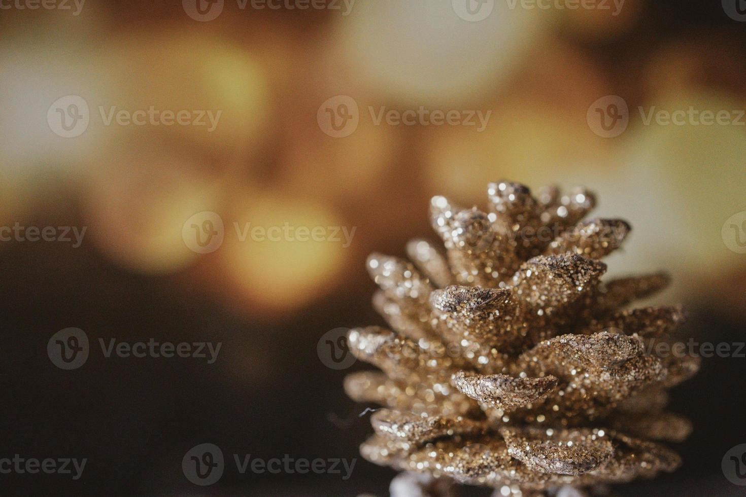 golden christmas cone on the background of bokeh in closeup photo