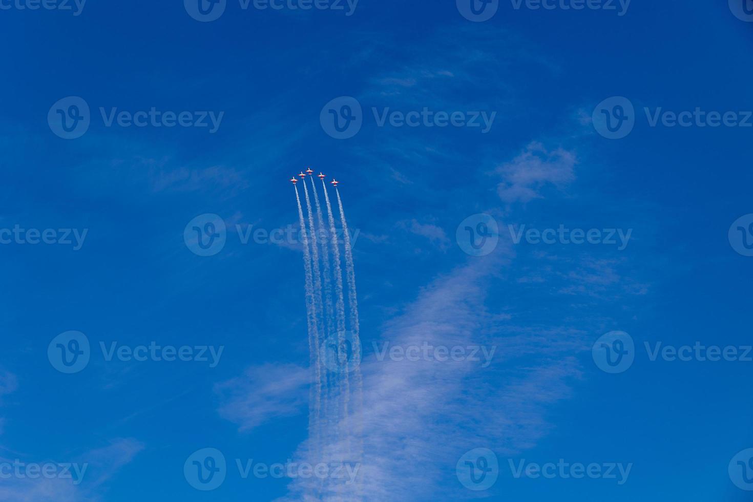 flight of five cessna planes over alicante smoke spanish flag against the blue sky photo