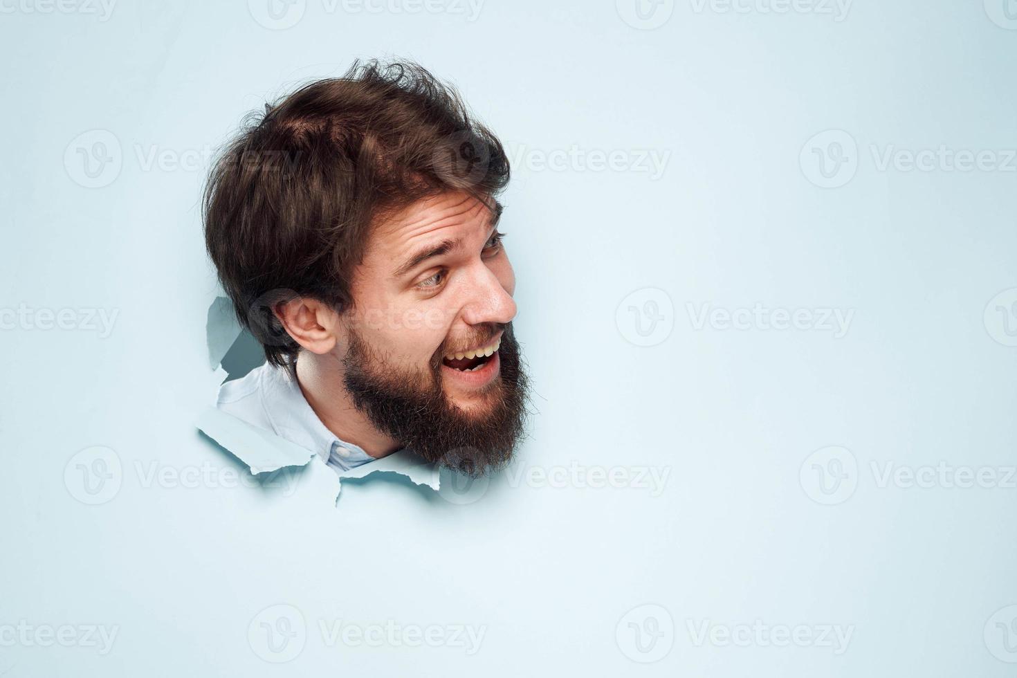 A disgruntled man looks out from behind the wall of the office manager's job photo