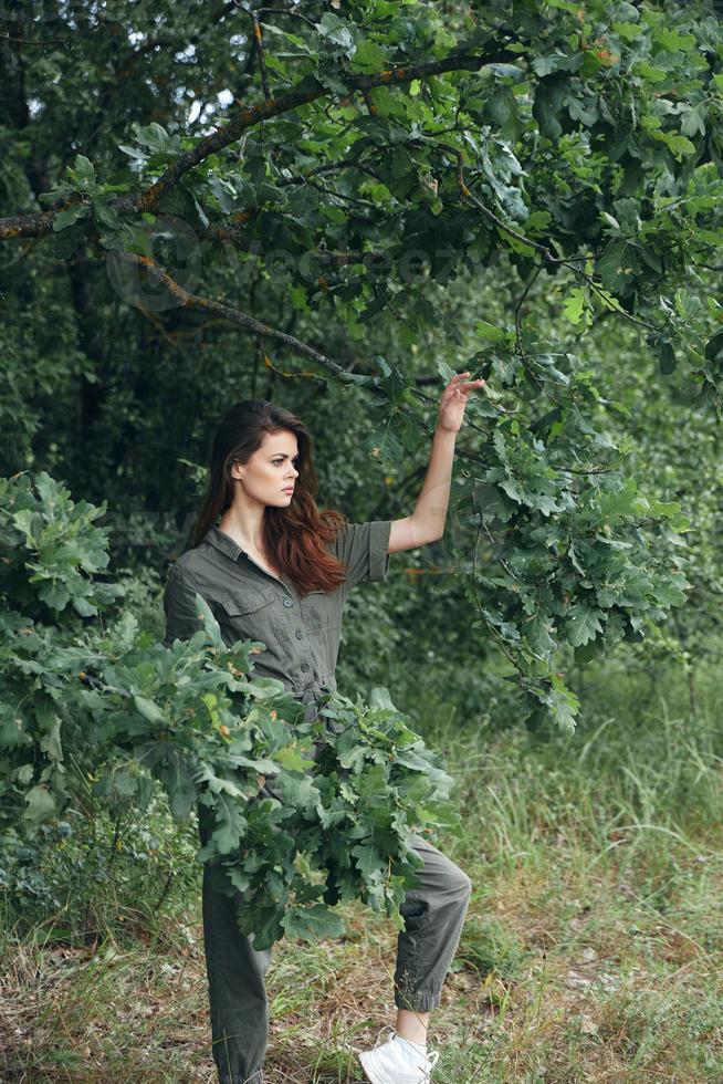 Woman outdoors Green leaves of nature trees side view photo
