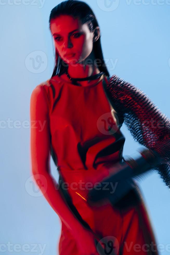 beautiful woman Glamor posing red light metal armor on hand Lifestyle unaltered photo
