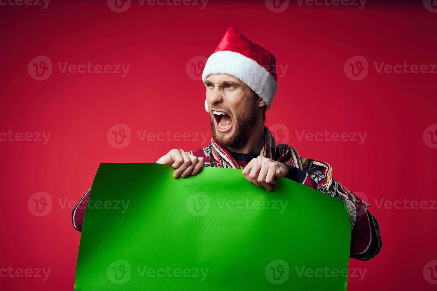 emotional man wearing santa hat green poster photo