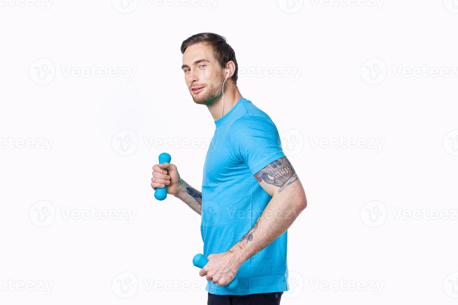 athletic man with dumbbells goes in for sports jogging white background side view photo