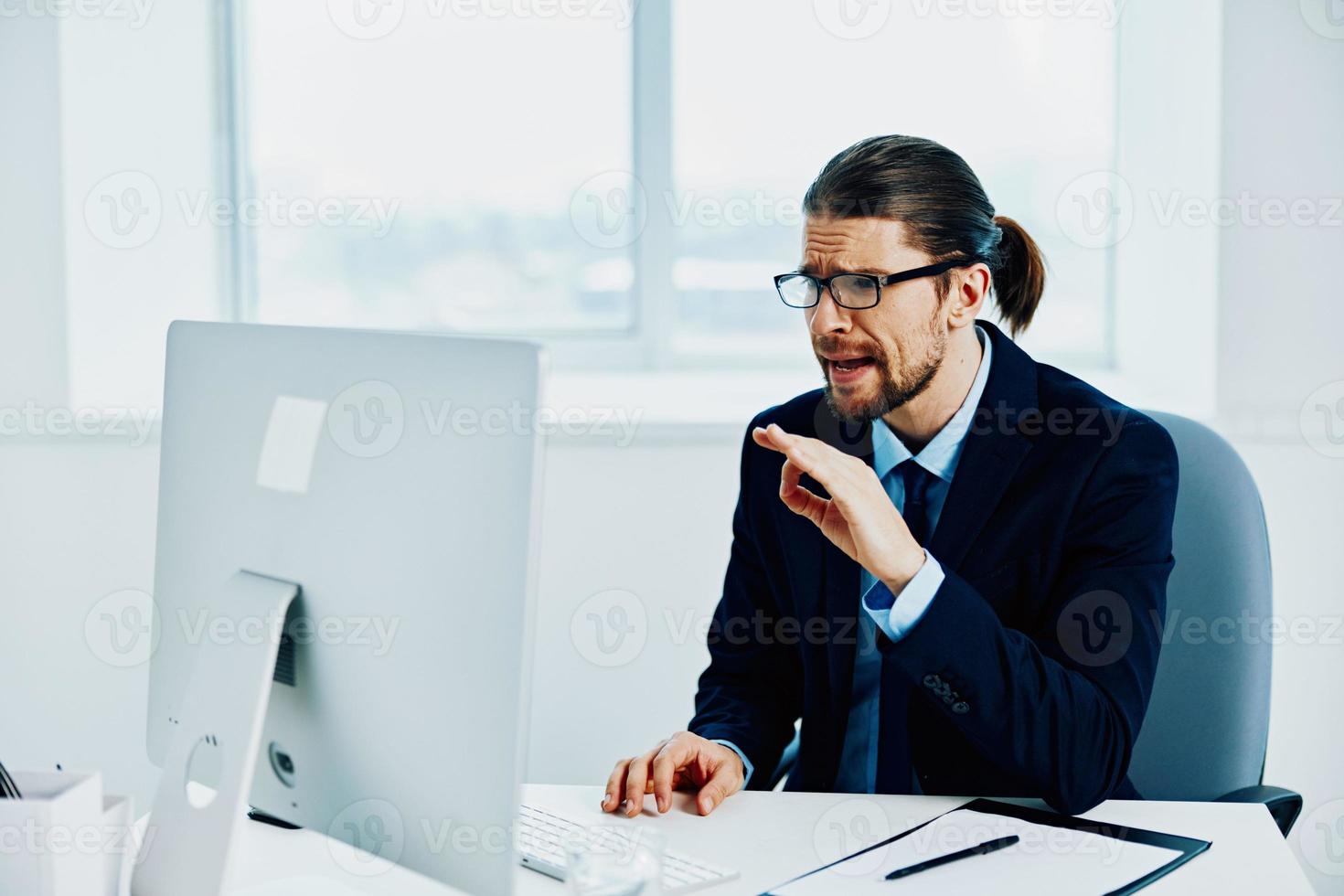 The man in a suit in the office gestures with his hands Lifestyle photo