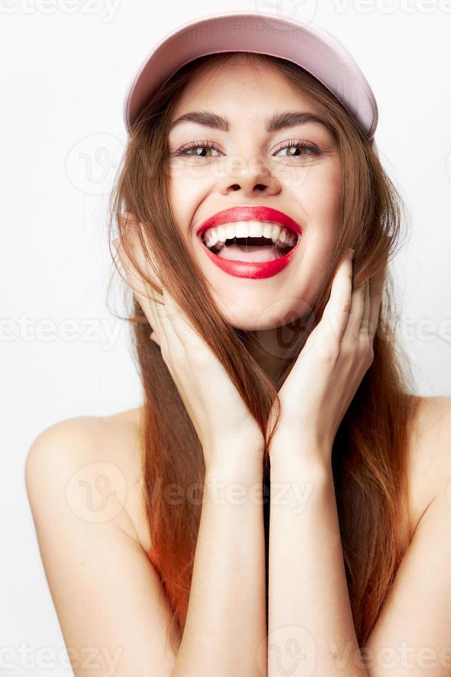 Portrait of a woman in a cap Cheerful smile of the hand near the face model photo