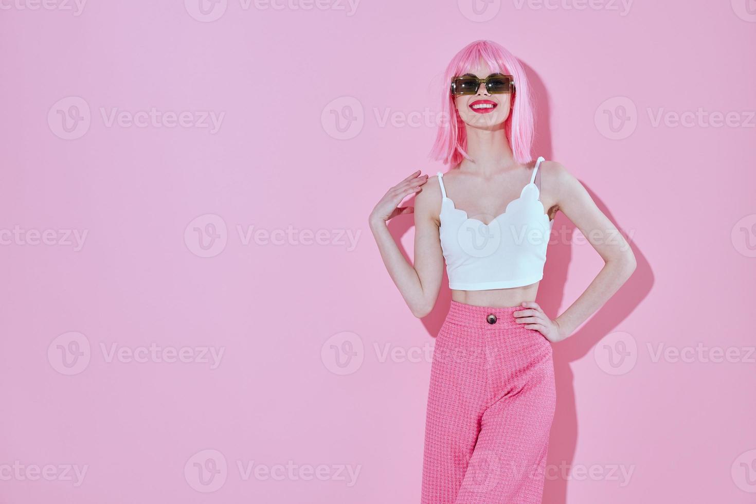Positive young woman attractive look pink wig stylish clothes color background unaltered photo
