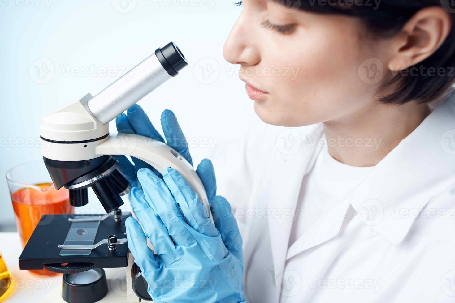 female laboratory assistant chemical solution research work science photo