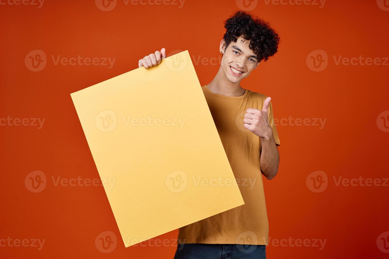 guy with curly hair studio advertising mockup red background photo