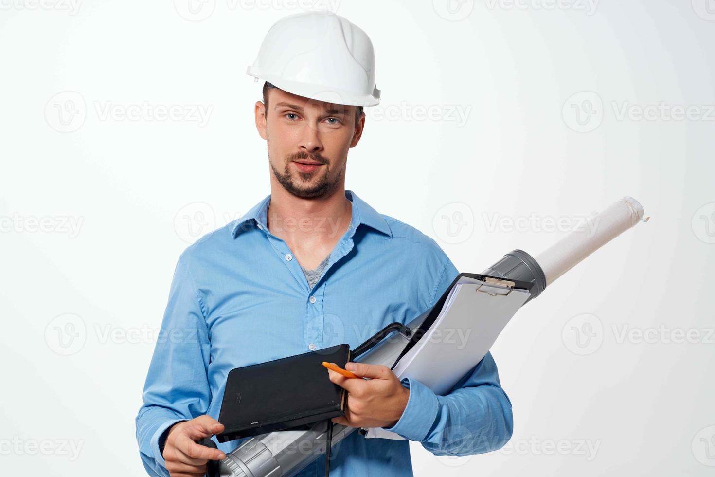 engineer in a construction helmet drawings documents construction photo