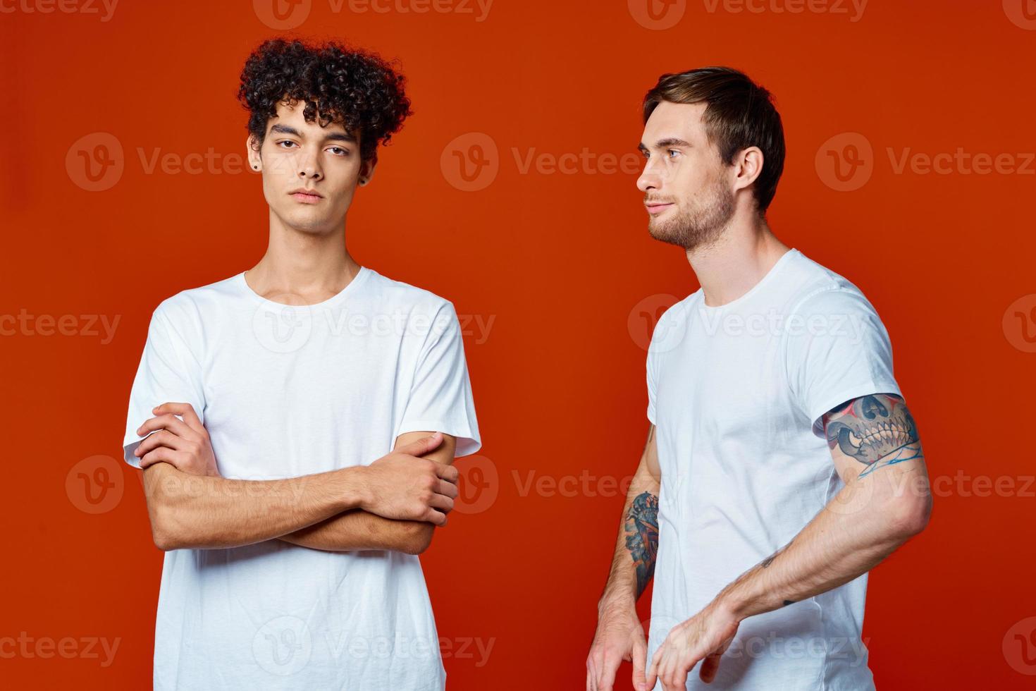 two friends in white t-shirts stand side by side isolated background communication photo