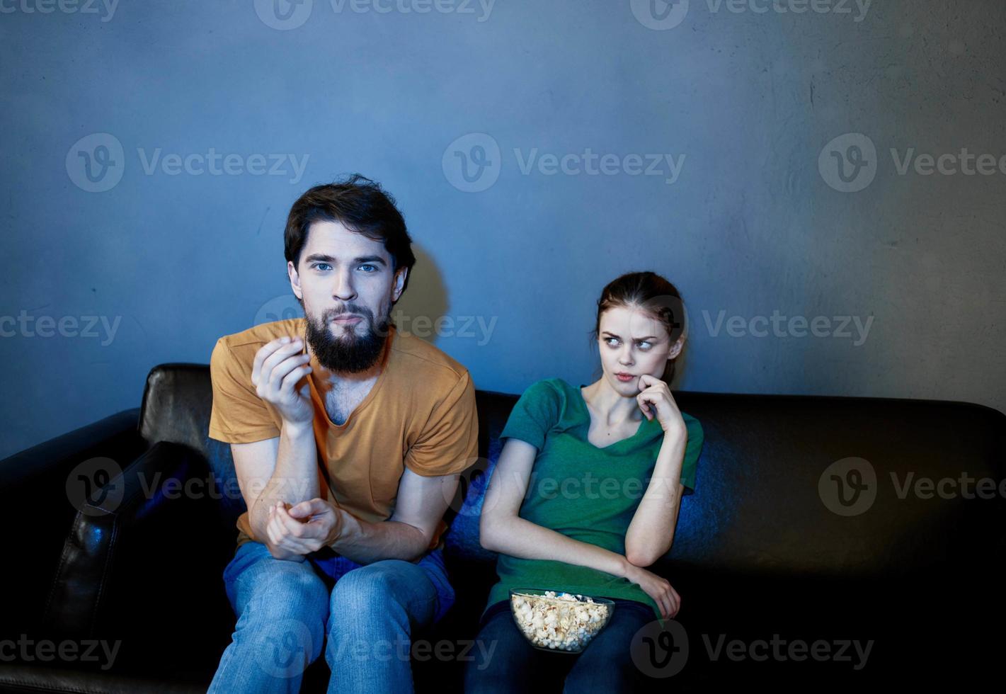 On the couch and a pretty woman is watching television shows photo