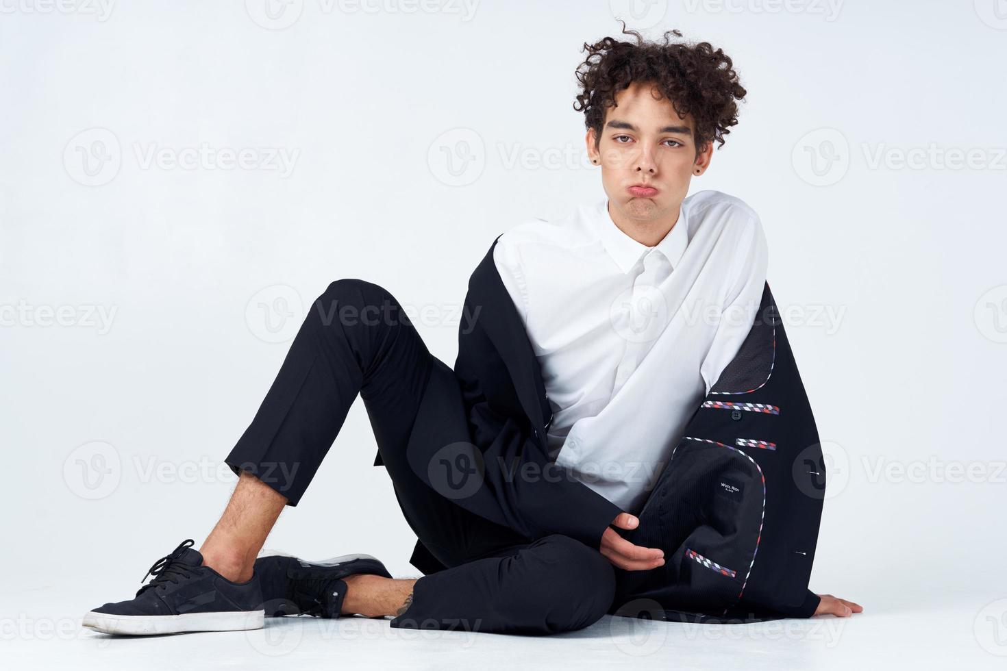 business man in a suit sitting on the floor self-confidence emotions photo