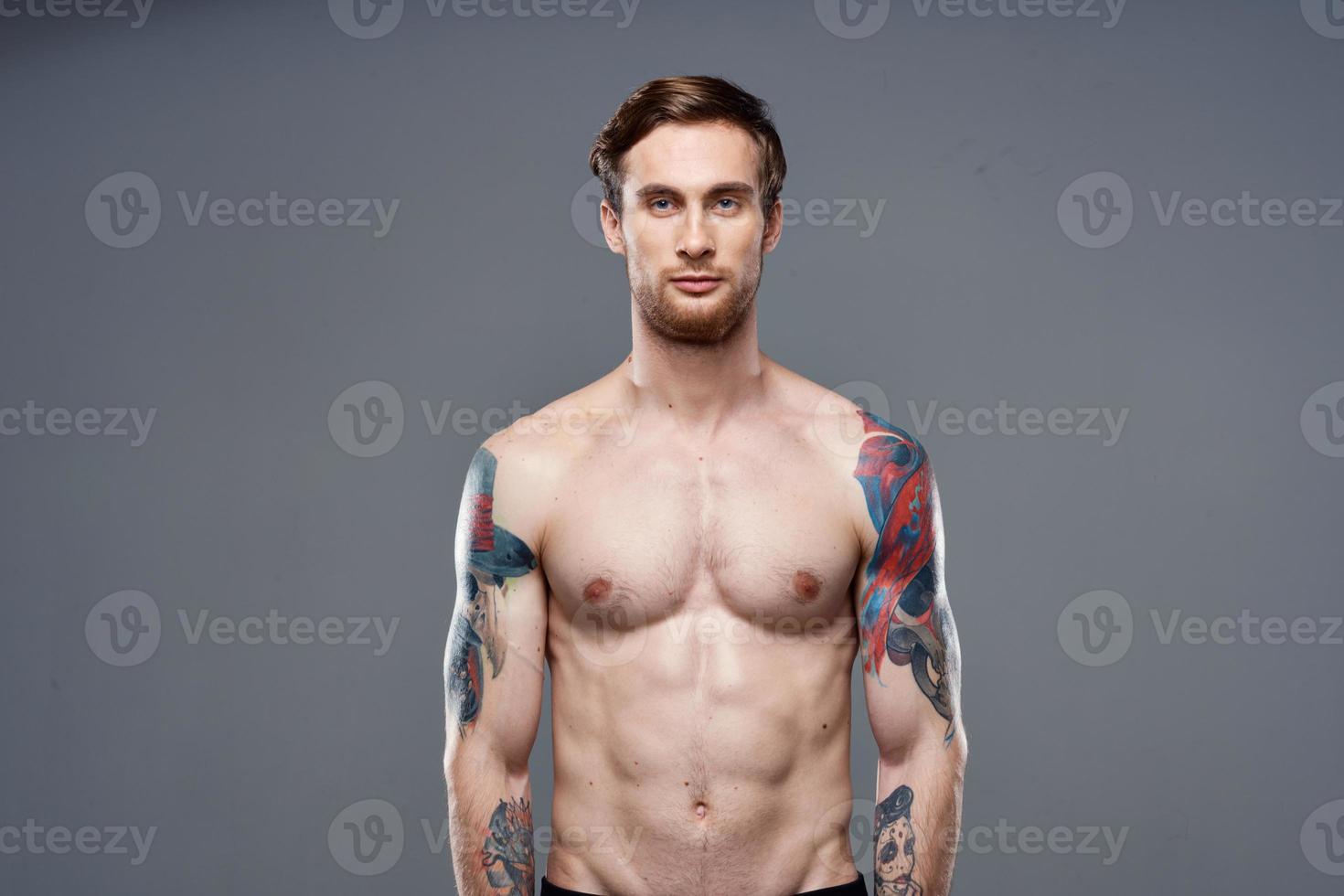 sporty man with tattoos on his arms workout cropped view photo