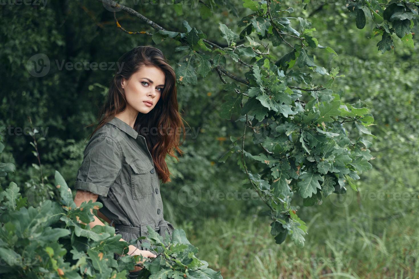 Woman in the forest Keeps his hands in his pockets with green leaves background photo