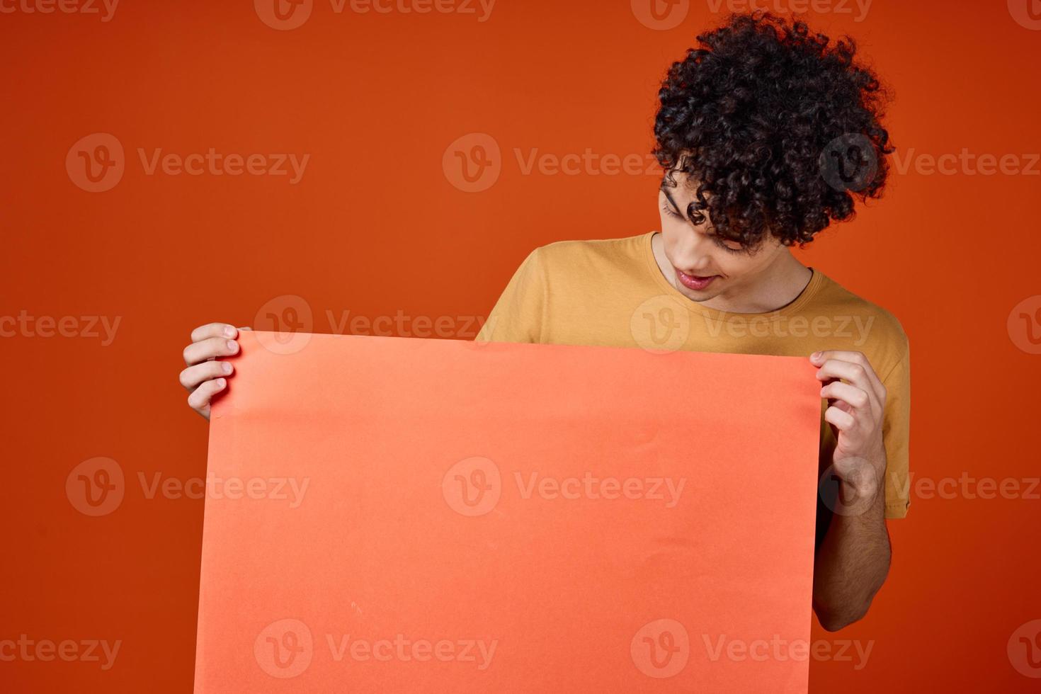 a guy in a yellow T-shirt with an island in his hands Copy Space advertisement photo