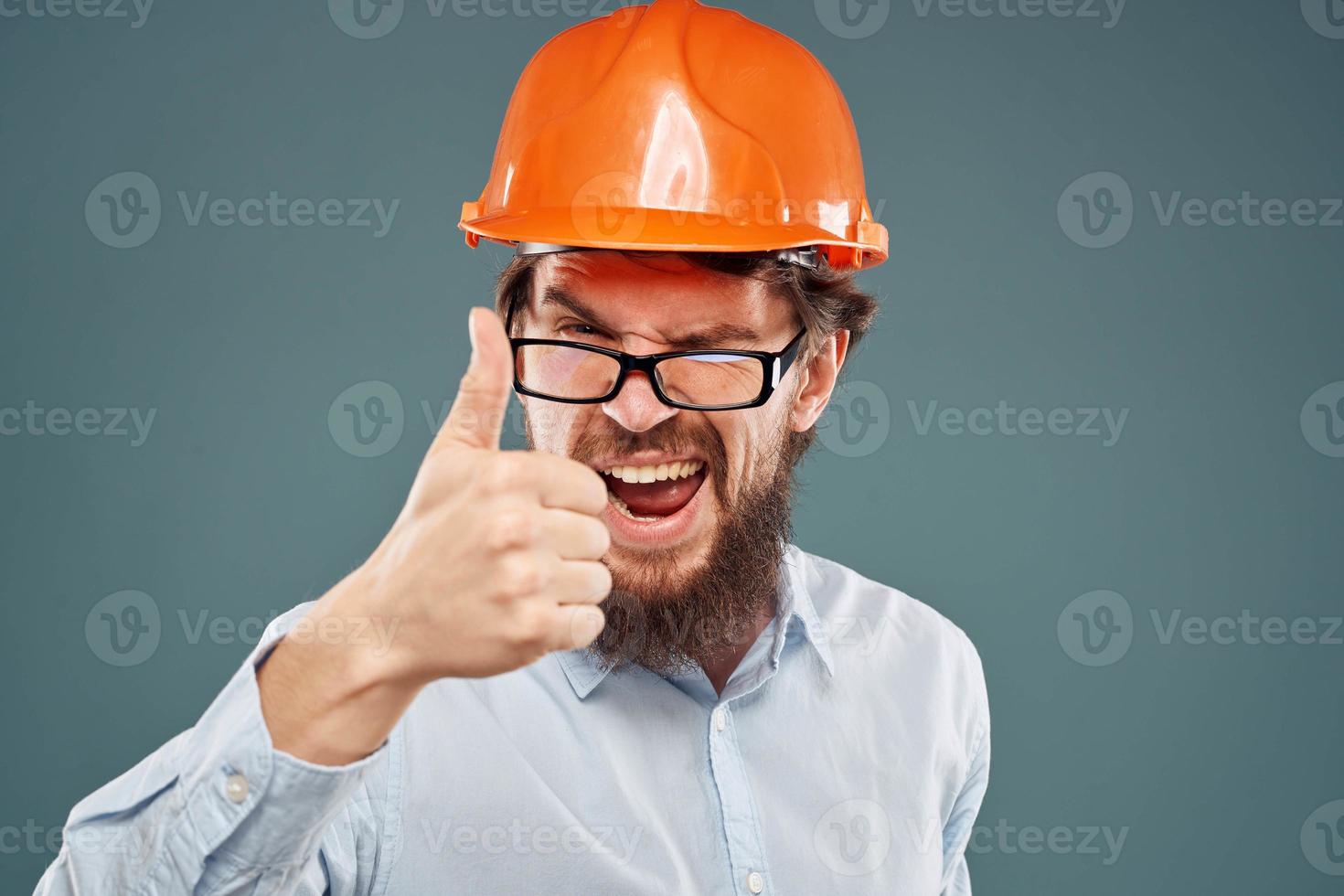 After wearing orange helmet shirt glasses hand gestures cropped view industry construction photo