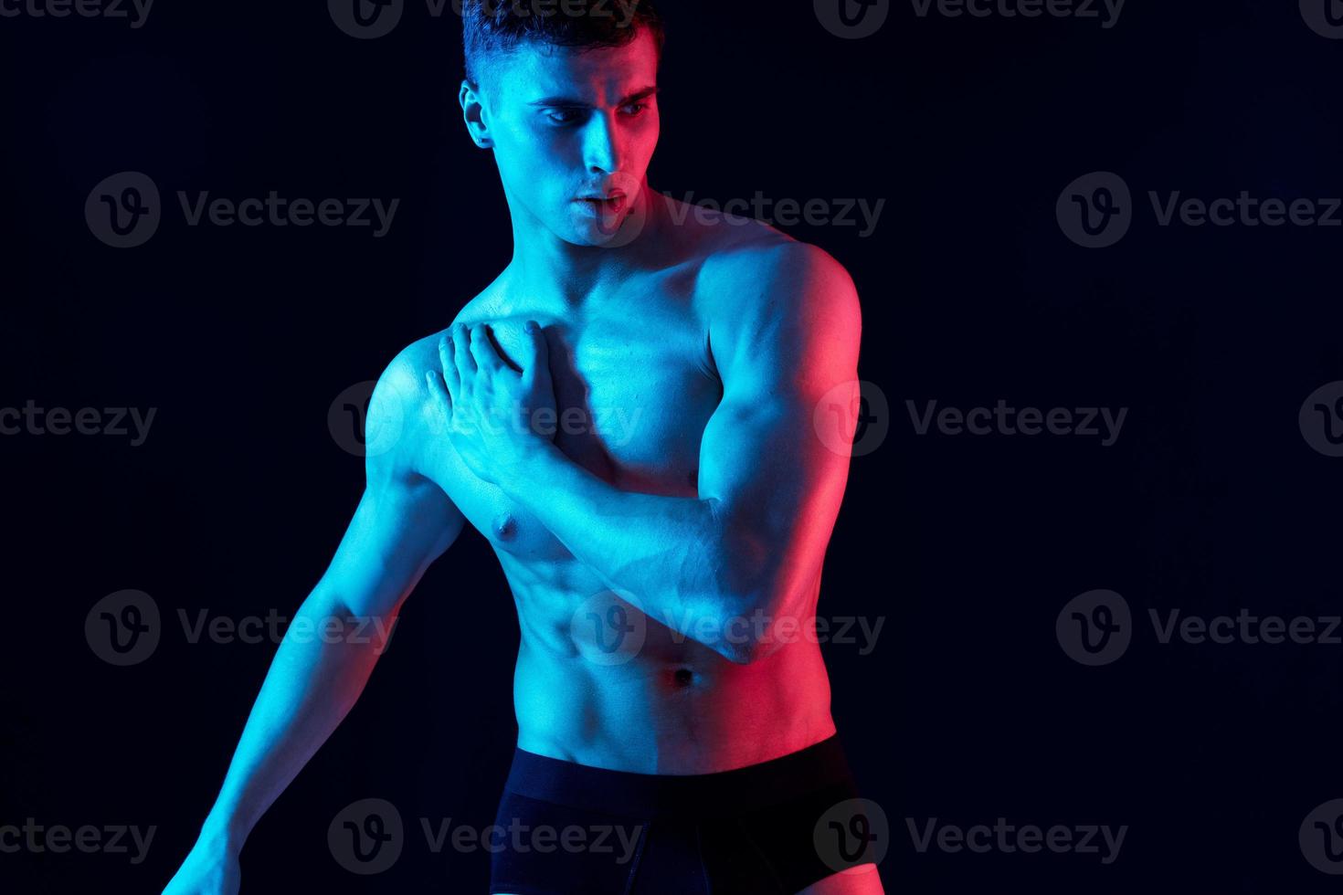 guy with pumped up torso and neon light isolated background photo