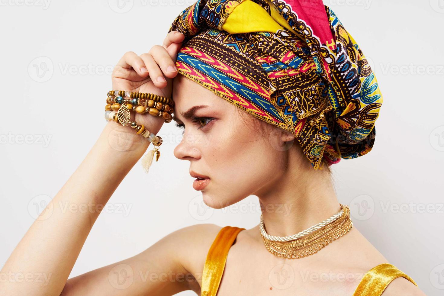 cheerful woman with multi-colored turban on her head decoration posing photo