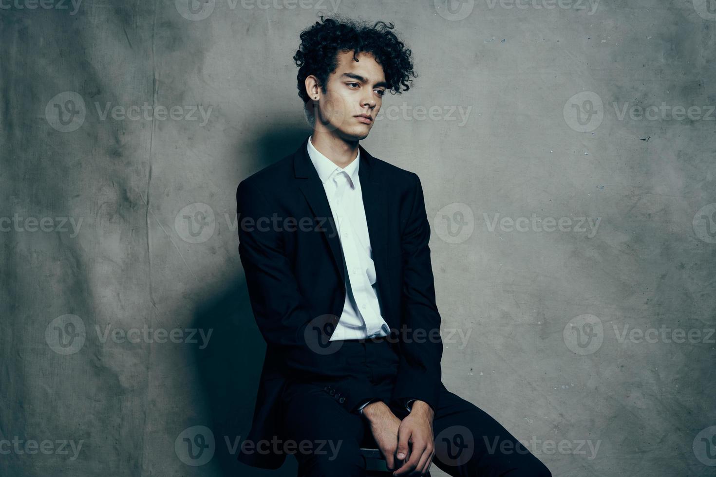man in black suit modern style studio official photo