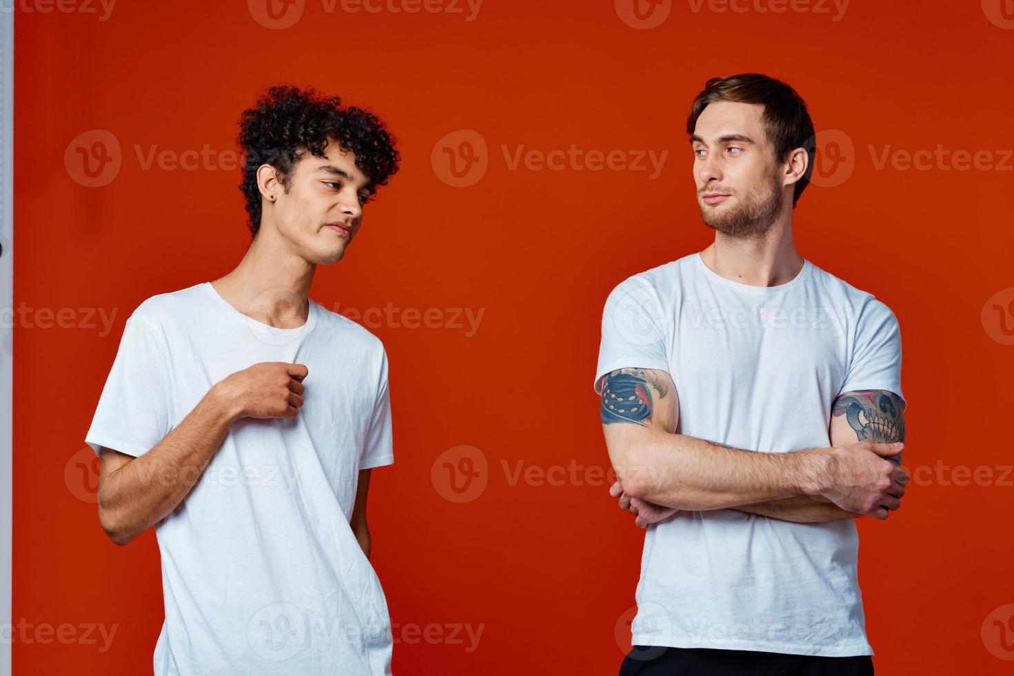 men in white t-shirts communication friendship red background photo