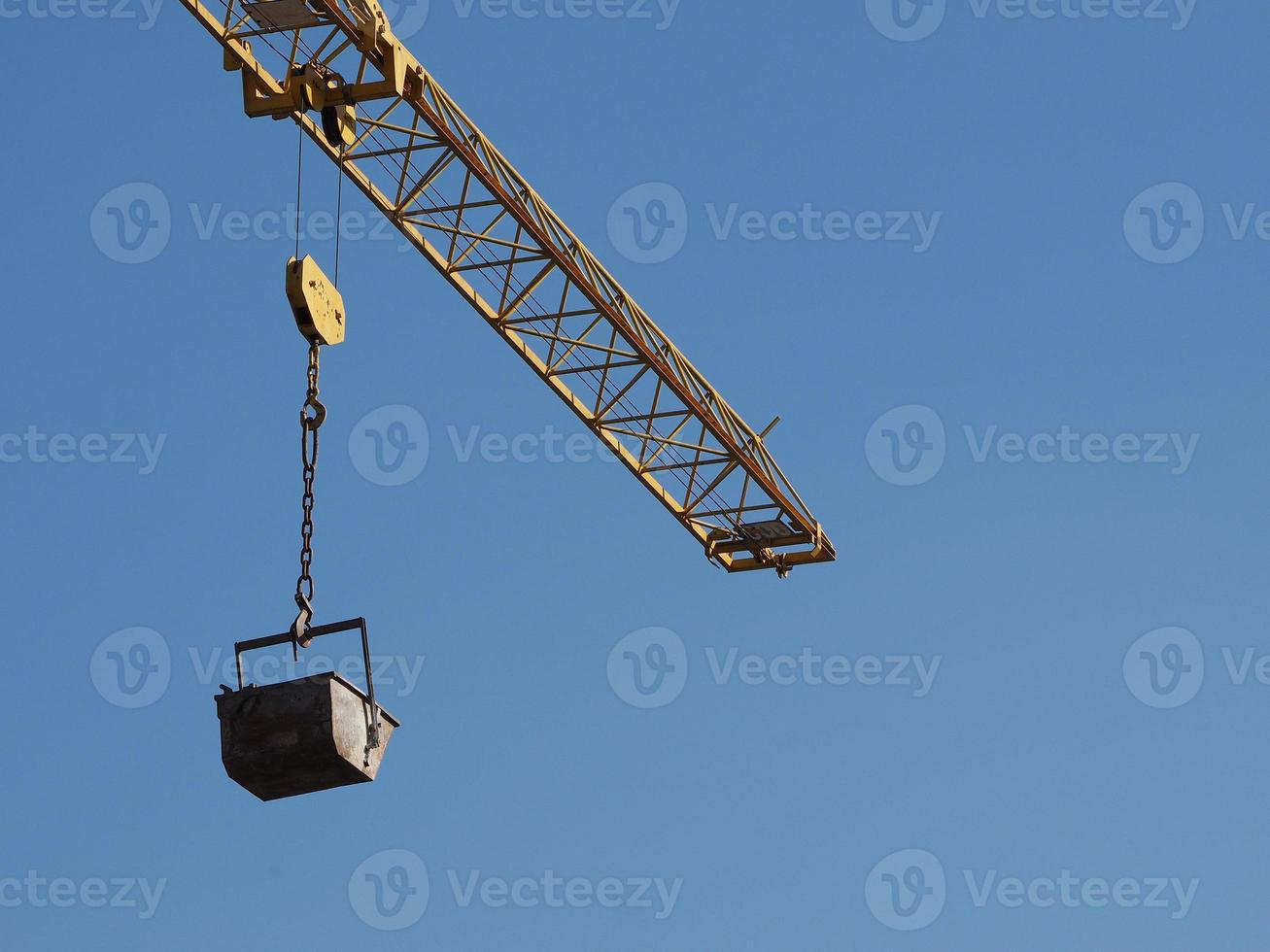 bucket attached to crane lifting hook photo