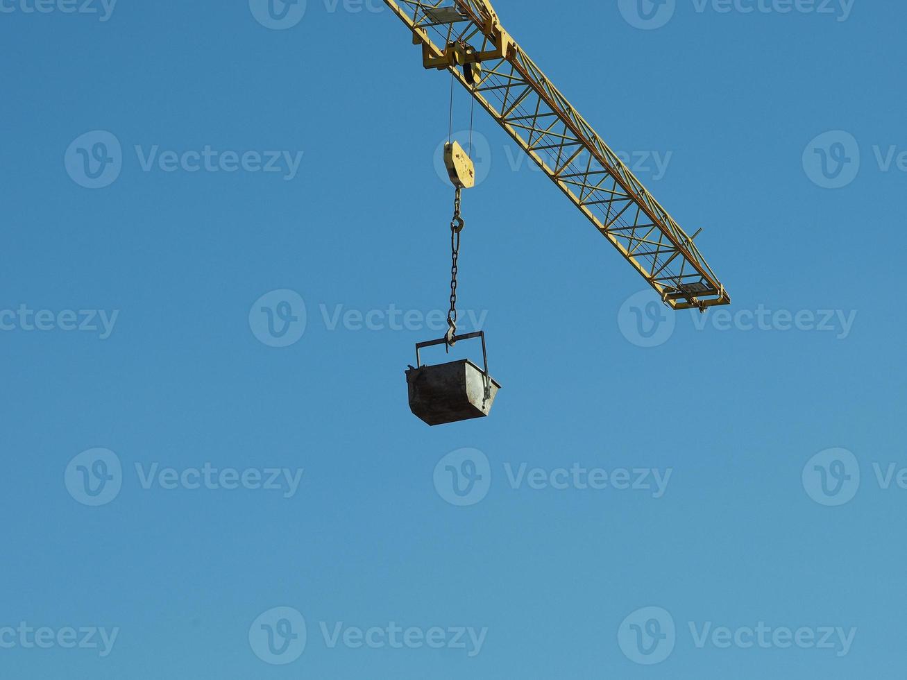 bucket attached to crane lifting hook photo